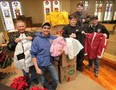 The Downtown Mission received a donation of over 500 winter coats Friday, Dec. 21, 2012, from the Carpenters Local 494 union members. Union members from left, Dwight Jones, Jonathan Yeryk, Martin Berg, with Ron Dunn, director of the Downtown Mission and Matthew Kwasnicki, representative/organizer with local 494 pose with some of the coats. (DAN JANISSE/The Windsor Star)