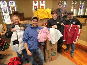 The Downtown Mission received a donation of over 500 winter coats Friday, Dec. 21, 2012, from the Carpenters Local 494 union members. Union members from left, Dwight Jones, Jonathan Yeryk, Martin Berg, with Ron Dunn, director of the Downtown Mission and Matthew Kwasnicki, representative/organizer with local 494 pose with some of the coats. (DAN JANISSE/The Windsor Star)