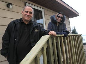 Aurelia Hudson, right, thanks Walter Branco, president of Noah Homes in Amherstburg, Ontario on December 19, 2012.  Branco and several contractors donated materials and time to complete a new roof and deck for the Amherstburg resident. (JASON KRYK/The Windsor Star)