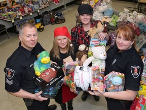 The Windsor Police made a sizeable donation of toys to the Windsor-Essex Children's Aid Society on Wednesday, Dec. 12, 2012, in Windsor, Ont. Sgt. Andrew Moxley, from left, Tina Gatt and Andrea Madden of the CAS and Const. Holly Burt pose with some of the toys. (DAN JANISSE/The Windsor Star)