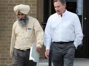 Karamjit Singh Grewal, 48, left, of Brampton Ont., walks out of Superior Court with his lawyer, Patrick Ducharme, Monday, Sept. 17,  2012.  (DAX MELMER/The Windsor Star)