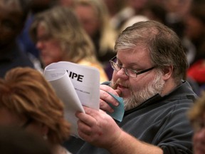 A CUPE worker looks over the proposed contract at the Caboto Club, Monday, Dec. 17, 2012.  (DAX MELMER/The Windsor Star)