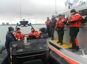 Boatcrews and law enforcement personnel from the U.S. Coast Guard and the Royal Canadian Mounted Police discuss planned joint smallboat training held along the shared US/Canada border in the Detroit River Dec. 10, 2012. U.S. Coast Guard photo by Petty Officer 2nd Class Jerry Minchew