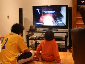 The Killen family playing with their donated Nintendo game system.