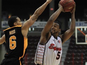 Windsor Express guard Victor Morris, right, shoots over London Lightning forward Adrian Moss during first half NBL basketball action at the WFCU Centre  December 21, 2012. (JASON KRYK/The Windsor Star)