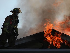 A firefighter battles a blaze on the 1000 block of Albert Road in this 2012 file photo.  (DAX MELMER/The Windsor Star)