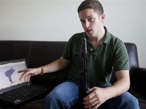 Wiki Weapons project leader Cody Wilson points to his laptop screen displaying an image of a prototype plastic gun on the screen, while holding a weapon he calls "Individual Mandate," in Austin, Texas. At least one group, called Defense Distributed, is claiming to have created downloadable weapon parts that can be built using the increasingly popular new-generation of printer that utilizes plastics and other materials to create 3-D objects with moving parts. Wilson says the group last month test fired a semiautomatic AR-15 rifle _ one of the weapon types used in the Connecticut elementary school massacre _ which was built with some key parts created on a 3-D printer. The gun was fired six times before it broke. (Associated Press/Statesman.com, )