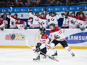 Team Canada forward Jonathan Drouin celebrates his goal with Canada defenceman Morgan Rielly, right, while playing against Russia during second period IIHF World Junior Championships hockey action in Ufa, Russia on Monday, Dec. 31, 2012. THE CANADIAN PRESS/Nathan Denette
