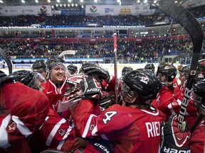 Team Canada teammates celebrate with goalie Malcolm Subban, centre, after defeating Team USA during third period IIHF World Junior Championships hockey action in Ufa, Russia, on Sunday, Dec. 30, 2012. THE CANADIAN PRESS/Nathan Denette