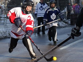 Alex Cunningham, 9, left, represents the Red Wings in a scrimmage game of ball hockey at the Windsor Classic on Riverside Drive west in downtown Windsor, Friday, Dec. 28, 2012. (DAX MELMER / The Windsor Star)
