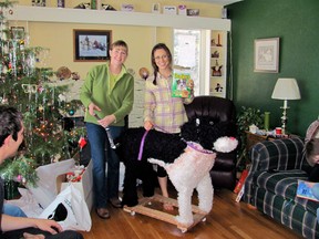 Katie Jackson shows, Margaret Smith, left, and her niece Katie Jackson with a stuffed dog Jackson received for Christmas in Lewistown, Mont. For the past three years, Jackson has asked for a Leonberger, one of those gentle giant breeds that can cost up to $1,500 and would occupy a good chunk of her Long Island City apartment. While her parents have good reasons for not granting her wish, including cost and size, other people aren't so sure why their numerous gift hints year after year yield a big fat nothing, even when their sought-after treasures aren't out-of-this-world expensive. (AP Photo/Becky Jackson)