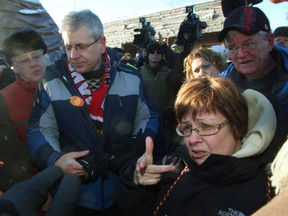 Attawapiskat First Nations Chief Theresa Spence(right)meets with NDP M.P. Charlie Angus(left) and other members of parliament in Ottawa, Sunday, December 30, 2012. THE CANADIAN PRESS/Fred Chartrand