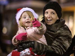 Scotlynn McCormick, left, and Hollie Menard enjoy the 2012 Essex Santa Claus Parade on Talbot Street North Saturday, Dec. 8, 2012.          (KRISTIE PEARCE/ The Windsor Star)