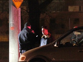 WINDSOR, ON.: DECEMBER 23, 2012 -- A police officer speaks with an occupant of a minivan that struck a woman Sunday, December 22, 2012 on Daytona Avenue. The woman suffered minor injuries. (KRISTIE PEARCE/ The Windsor Star)