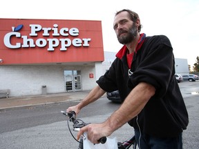 Cliff Miners, 47, is photographed outside of the Price Chopper on Crawford Avenue Sunday October 14, 2012 in Windsor, Ont. Miners relies on his bike for transportation and said the upcoming closure of the store will leave a grocery store void for west end residents.