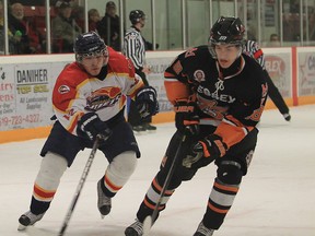 Essex 73's Curtis Prymack handles the puck past Kingsville Comets Frank Desjardin during second period hockey action in Essex, Ontario on December 18, 2012. (JASON KRYK/The Windsor Star)