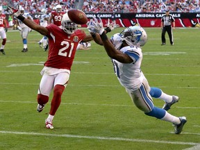 Detroit wide receiver Calvin Johnson, right, cannot pull in a pass as Arizona cornerback Patrick Peterson Sunday, Dec. 16, 2012, in Glendale, Ariz. (AP Photo/Ross D. Franklin)