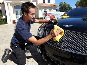 Luke Piskovic, owner of Piskey's Mobile, details the grille of a Bentley.  (NICK BRANCACCIO/The Windsor Star)