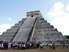 People gather in front of the Kukulkan Pyramid in Chichen Itza, Mexico, Thursday, Dec. 20, 2012. American seer Star Johnsen-Moser led a whooping, dancing, drum-beating ceremony Thursday in the heart of Mayan territory to consult several of the life-sized crystal skulls, which adherents claim were passed down by the ancient Maya. (AP Photo/Israel Leal)