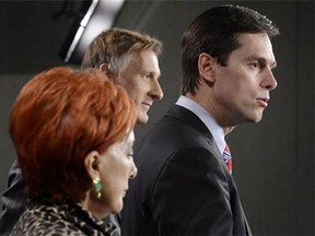 Conservative MP Russ Hiebert, right, speaks about his Private Members Bill, C-377, regarding financial transparency for labour organizations during a news conference on Parliament Hill in Ottawa on Thursday, Dec.13, 2012. THE CANADIAN PRESS/Adrian Wyld