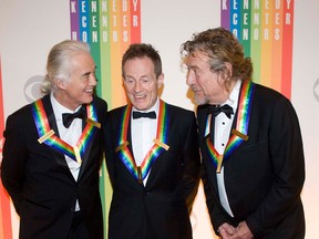 2012 Kennedy Center Honorees and members of the band Led Zeppelin, from left, Jimmy Page, John Paul Jones, and Robert Plant chat on the red carpet after arriving at the Kennedy Center for the Performing Arts for the 2012 Kennedy Center Honors Performance and Gala Sunday, Dec. 2, 2012 at the State Department in Washington. (AP Photo/Kevin Wolf)