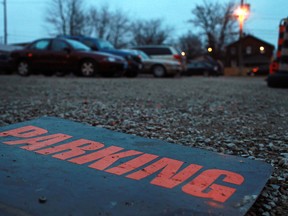 In this file photo, a parking sign lays on the ground at an unpaved parking lot on the 200 block of Glengarry Avenue, Monday, Dec. 17, 2012.  (DAX MELMER/The Windsor Star)
