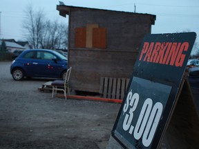 A parking sign to an unpaved parking lot on the 200 block of Glengarry Avenue is pictured, Monday, Dec. 17, 2012.  (DAX MELMER/The Windsor Star)