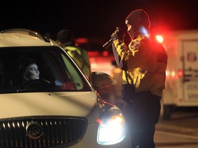 A Windsor Police officer questions a motorist during a joint forces R.I.D.E. program on Riverside Drive in east Windsor in this file photo. (JASON KRYK/The Windsor Star)