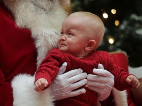 Camden Fleming, 8 months, wasn't too impressed with his first encounter with Santa, Monday, Dec. 17, 2012, during a photo session at the Devonshire Mall in Windsor, Ont. (DAN JANISSE/The Windsor Star)