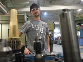 Shane Therrien is an apprentice CNC machinist with Valiant Corp., where he was hired through an on-the-job training program. (JASON KRYK/ The Windsor Star)