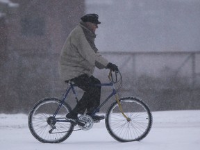 A man rides his bike along Wyandotte Street west as a winter storm hits the Windsor area, Wednesday, Dec. 26, 2012.  (DAX MELMER/The Windsor Star)