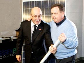 Ontario Finance Minister Dwight Duncan,right, and Tecumseh Mayor Gary McNamara throw the startup switch for one of Canada's largest rooftop solar systems at Tecumseh Arena in 2010 (Windsor Star file photo)