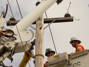 Hydro technicians upgrade power lines. (Postmedia News files)