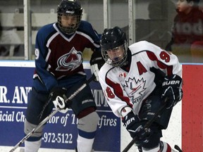 Windsor Jr. Spitfire David Moore, right, makes a move around Amherstburg's Jake Frank in bantam major action during the 53rd Annual International Bantam Midget Hockey tournament  at WFCU Centre, Thursday Dec. 27, 2012. (NICK BRANCACCIO/The Windsor Star)