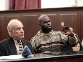 Naeem Davis, right, stands in front of Judge Lynn Kotler during his arraignment on murder charges Wednesday, Dec. 5, 2012, in New York. With him is attorney Stephen Pokart. Davis was arrested Tuesday in the death of 58-year-old New York city subway rider Ki-Suck Han, who was shoved onto the tracks. (AP Photo/Daily News, William C. Lopez, Pool)