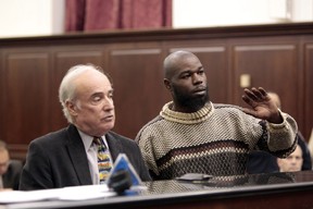 Naeem Davis, right, stands in front of Judge Lynn Kotler during his arraignment on murder charges Wednesday, Dec. 5, 2012, in New York. With him is attorney Stephen Pokart. Davis was arrested Tuesday in the death of 58-year-old New York city subway rider Ki-Suck Han, who was shoved onto the tracks. (AP Photo/Daily News, William C. Lopez, Pool)