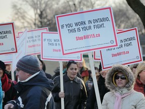 Teachers with the Greater Essex County District School Board staged a one-day strike Wednesday, Dec. 18, 2012, along with about 35,000 other teachers at seven other school boards across Ontario as part of their ongoing battle against Bill 115. Here teachers picket in front of Southwood Public School in Windsor,Ont. (DAN JANISSE/The Windsor Star)