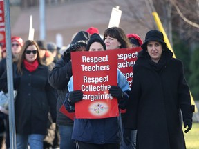 Teachers with the Greater Essex County District School Board staged a one-day strike Wednesday, Dec. 18, 2012, along with about 35,000 other teachers at seven other school boards across Ontario as part of their ongoing battle against Bill 115. Here teachers picket in front of the board office in Windsor,Ont. (DAN JANISSE/The Windsor Star)