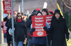 Teachers with the Greater Essex County District School Board staged a one-day strike Wednesday, Dec. 18, 2012, along with about 35,000 other teachers at seven other school boards across Ontario as part of their ongoing battle against Bill 115. Here teachers picket in front of the board office in Windsor,Ont. (DAN JANISSE/The Windsor Star)