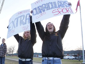 Rebecca Krug (L) and Alex Leroux, students from Amherst Secondary School protest Tuesday, Dec. 18, 2012, in front of the OSSTF office on Lauzon Parkway in Windsor, Ont. They say they are pawns in the teacher's labour dispute. (DAN JANISSE/The Windsor Star)