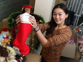 Karen Wang, student trustee for the Windsor Essex County District School Board prepares toys and decorations that will be delivered to needy families.  The goods are being stored at Massey Secondary School.  Ongoing teacher actions have resulted in the cancellation of a party for underprivileged children.  The toys will still be delivered thanks to the hard work of students.  (JASON KRYK/ The Windsor Star)