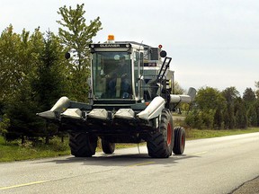 File photo of a farmer driving a combine in Essex County. (Windsor Star files)