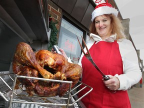 Linda Lee-Lapoint of the Patio Palace in Windsor, watches over a turkey cooking on her barbecue. Cooking the bird on the barbecue is an option for the holiday season. (DAN JANISSE / The Windsor Star)