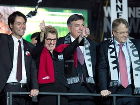 Ontario Liberal Party leadership candidate Kathleen Wynne celebrates with fellow candidates Eric Hoskins (left), Gerard Kennedy (right) and Charles Sousa after they gave her their support at the convention in Toronto on Saturday Jan. 26, 2013. THE CANADIAN PRESS/Frank Gunn