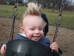 Maddox Wilson, 2, enjoys the swing at Willistead Park on Saturday, Jan. 12, 2013.  Maddox and his mother, Sabina Leszczynski, were enjoying the record-breaking temperatures.  (DAX MELMER / The Windsor Star)