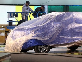 Lots of product still under wraps as Detroit Mayor Dave Bing and media members took the Mayor's walking tour and preview of the Detroit International Auto Show at Cobo Center Thursday January 10, 2013.