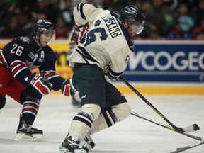 Windsor's Josh Ho-Sang, right, is checked by Oshawa's Geoffrey Schemitsch at the WFCU Centre. (DAX MELMER/The Windsor Star)