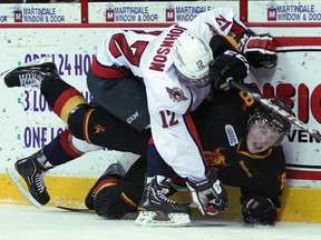 Windsor's Ben Johnson, left, checks Belleville's Jake Worrad at the WFCU Centre. (JASON KRYK/The Windsor Star)