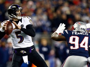 Joe Flacco #5 of the Baltimore Ravens gets pressured by Justin Francis #94 of the New England Patriots during the 2013 AFC Championship game at Gillette Stadium on January 20, 2013 in Foxboro, Massachusetts.  (Photo by Jared Wickerham/Getty Images)