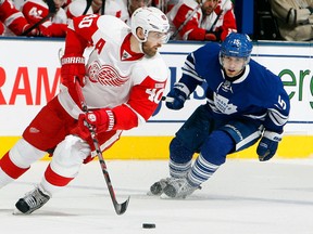 Detroit's Henrik Zetterberg, left, is checked by Toronto's Matthew Lombardi at The Air Canada Centre. (Photo by Abelimages/Getty Images)